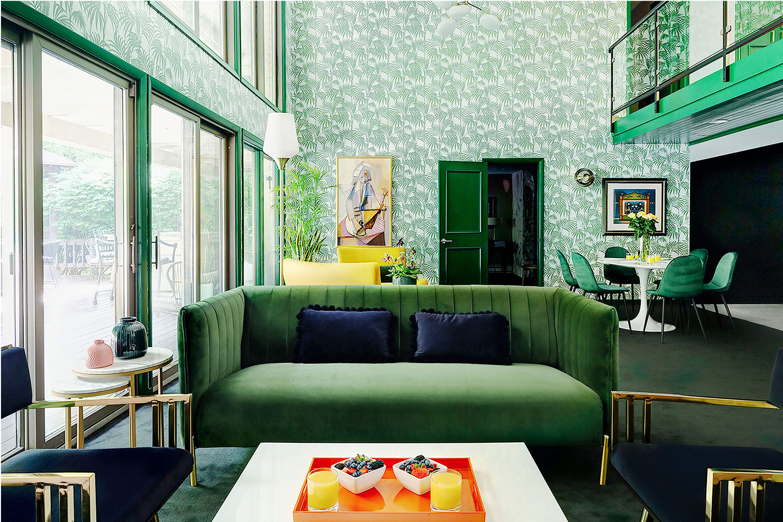 Inside the living room with green furniture and green wallpaper