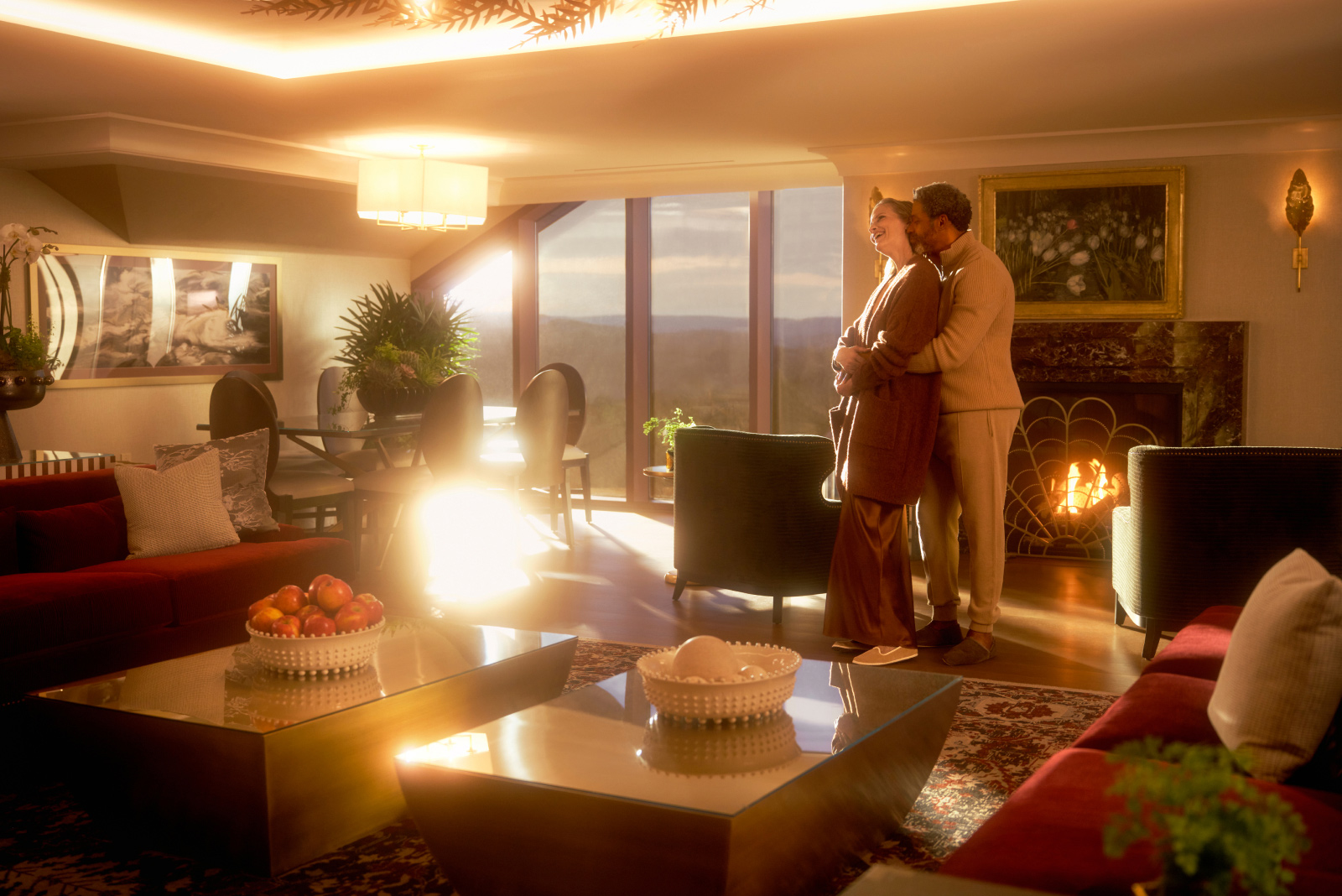 A luxurious penthouse suite with high-end furnishings, large windows offering stunning views, and plush amenities.